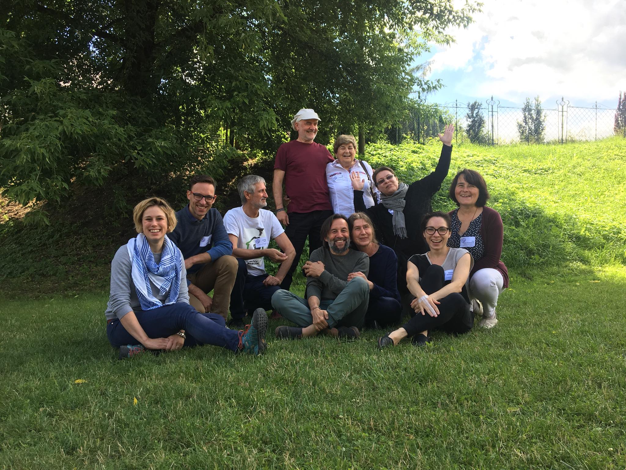 group of people sitting on the grass