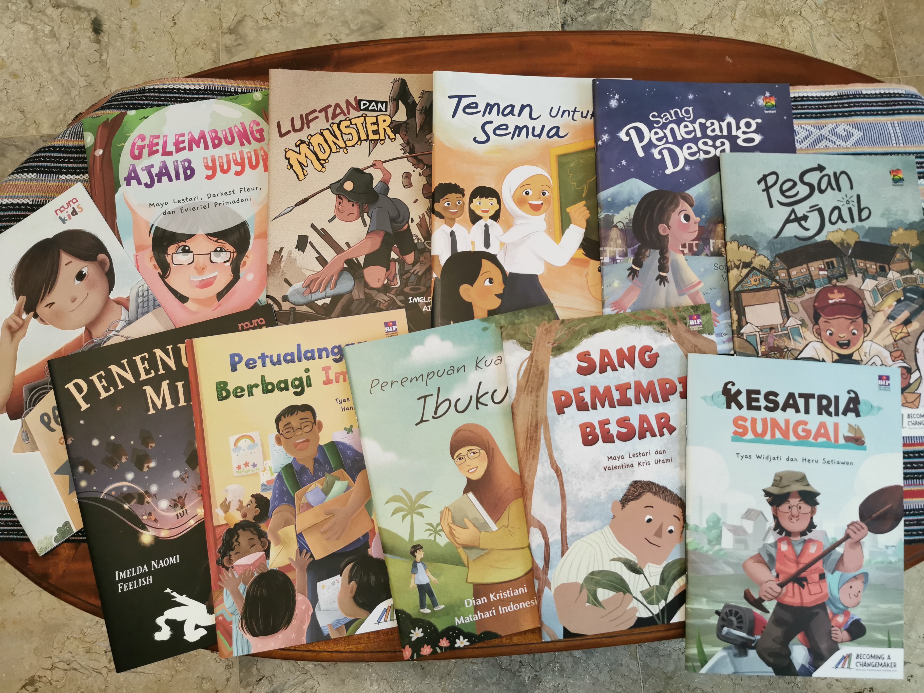 The children's books from Ashoka Indonesia's "Becoming a Changemaker" series lie displayed on a table