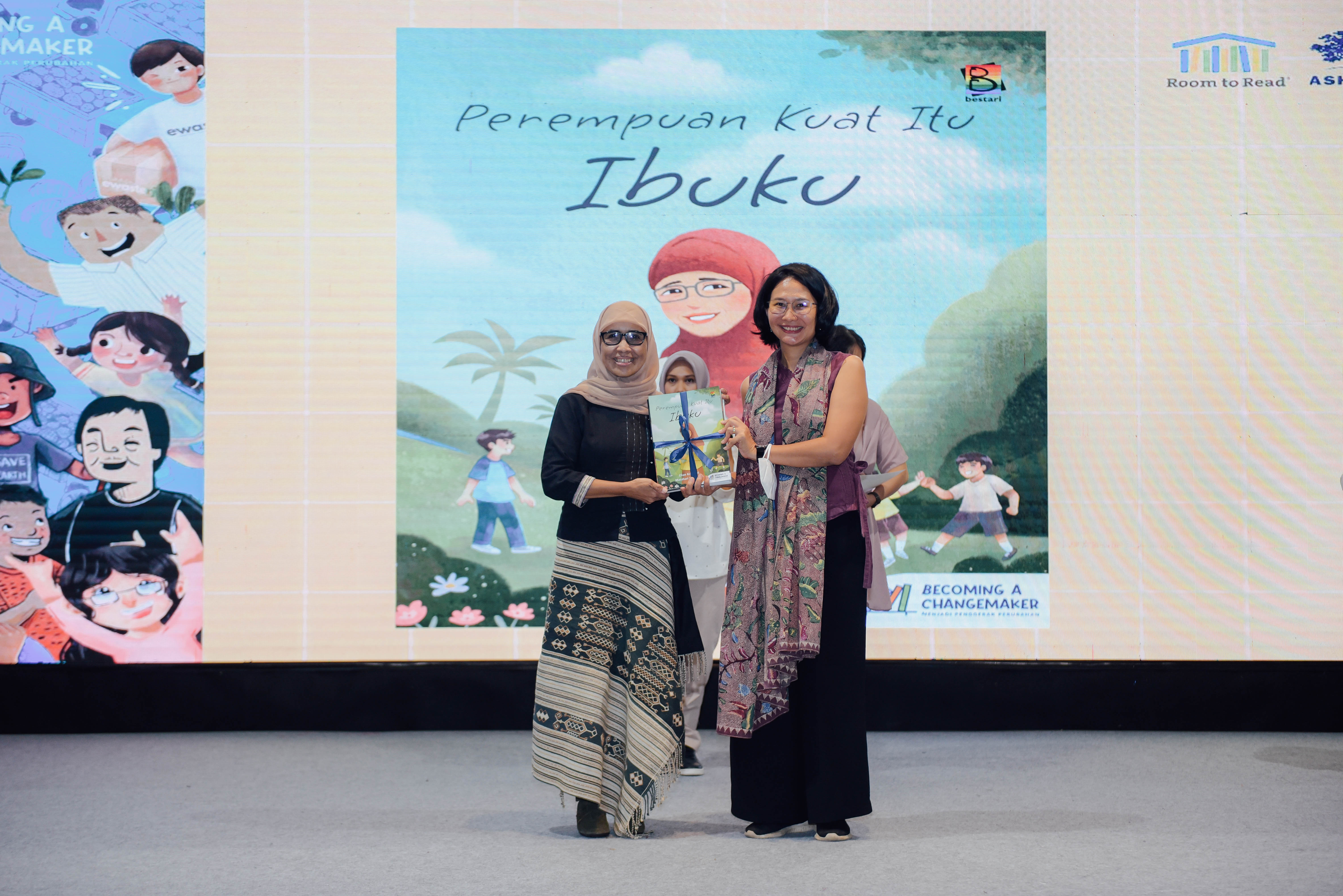 Nani Zulminarni & Amelia Hapsari pose with Nani’s book from Ashoka Indonesia's "Becoming a Changemaker" series at the Indonesia International Book Fair