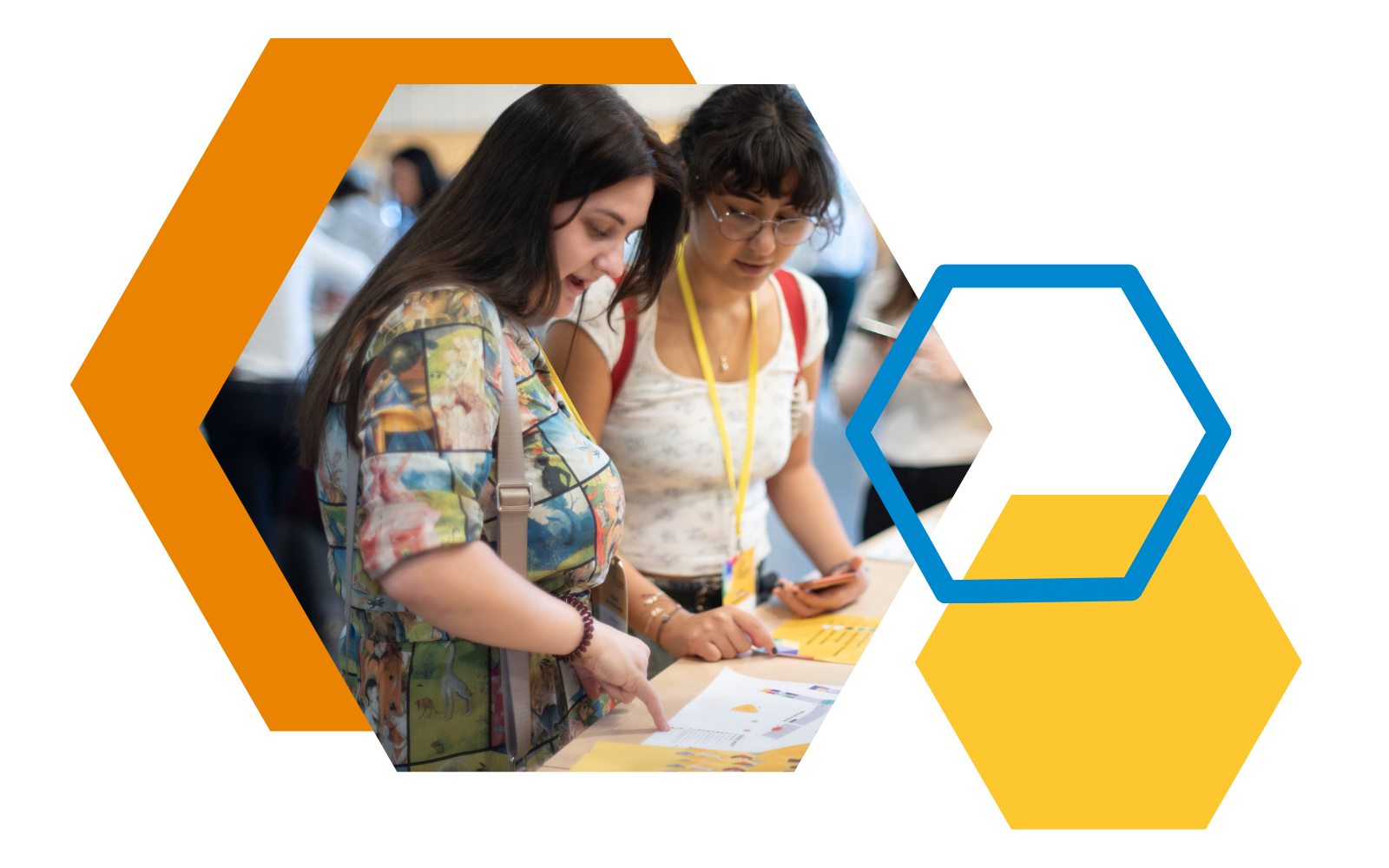 Two young women standing in front of registration desk at a conference