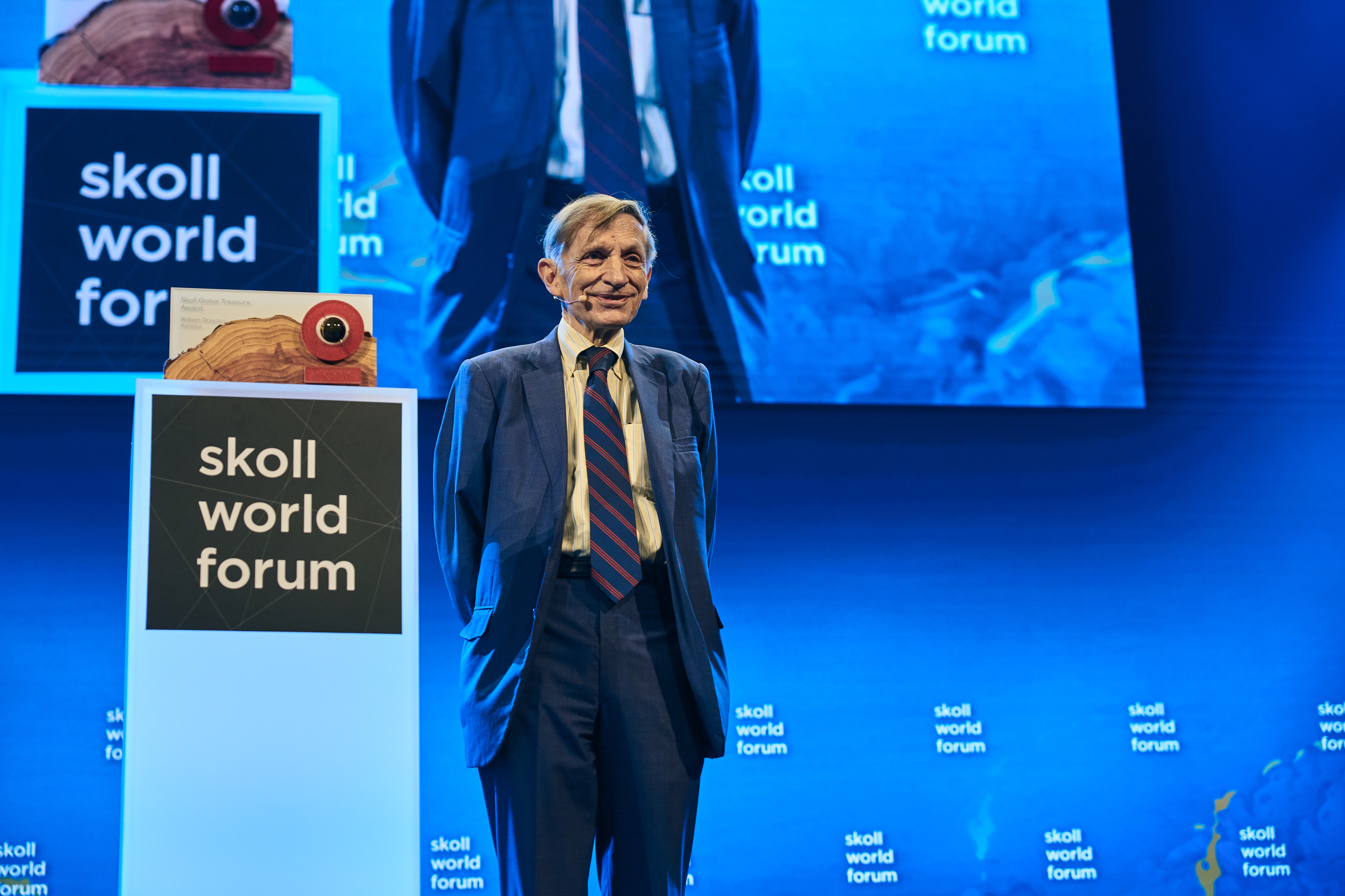 Bill Drayton facing audience front profile on stage at the Skoll Social Forum 2025