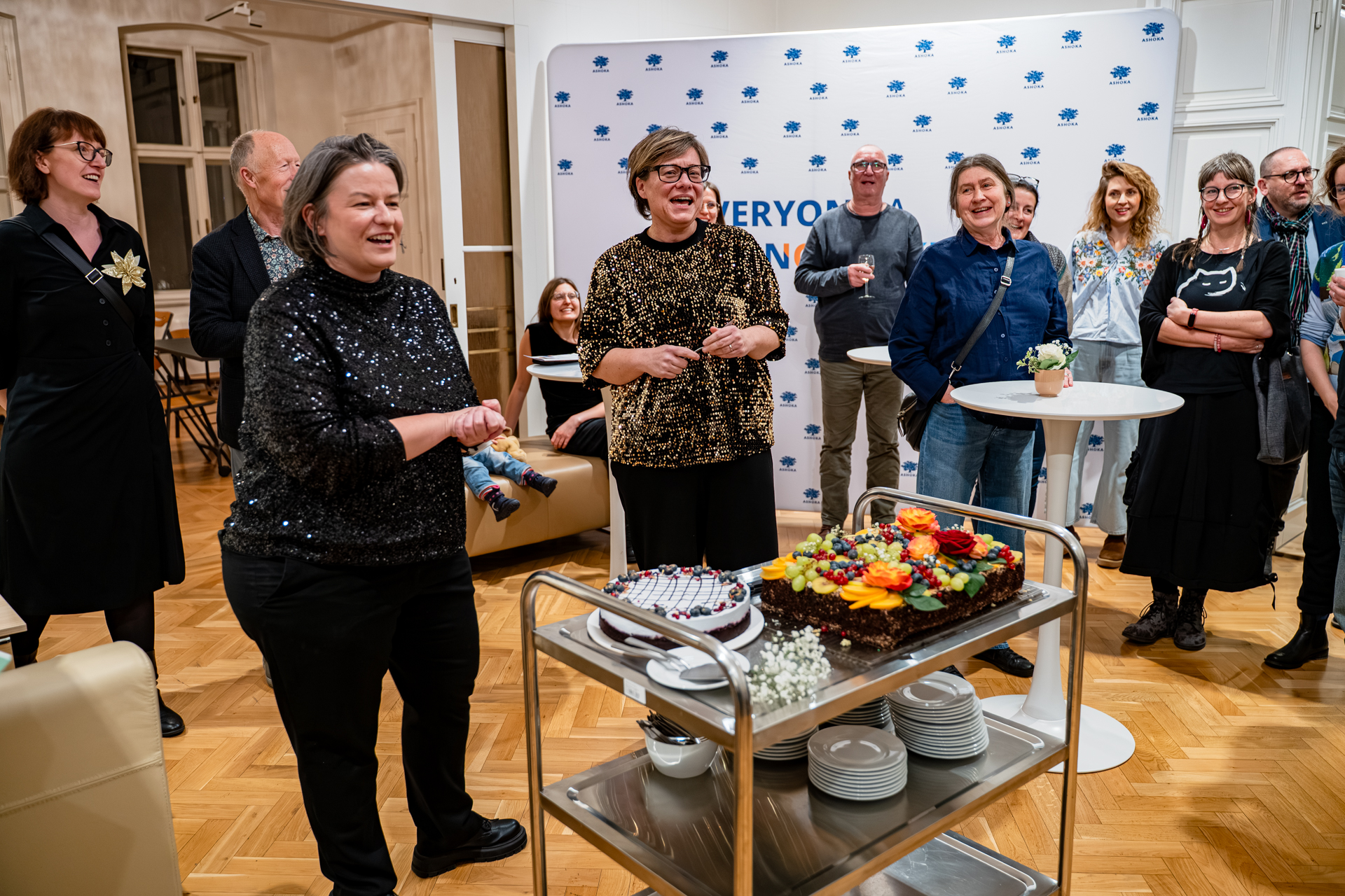 People cutting a cake