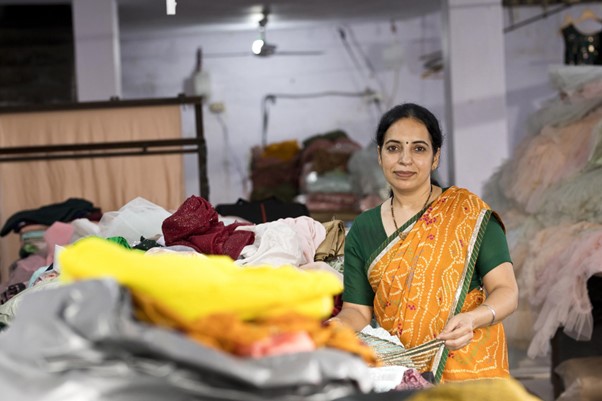 Person with a sari on surrounded by fabric