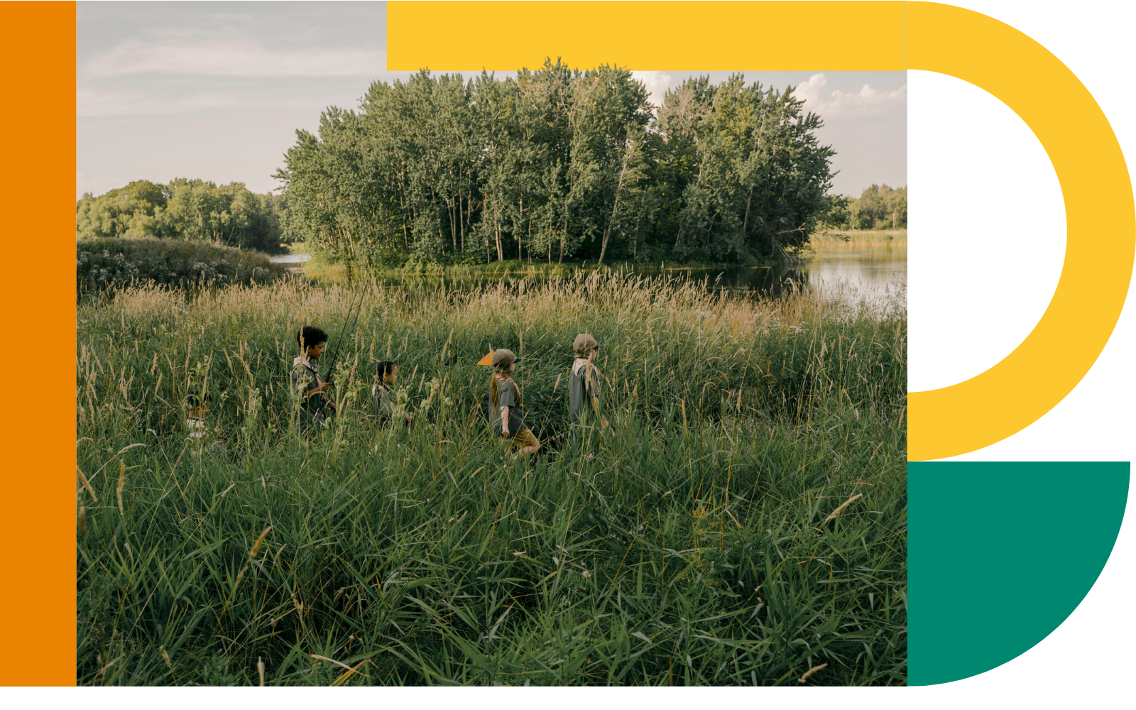 A group of children walks through tall grass near a lake and trees in a natural landscape. The photo is framed by large green, yellow, and orange graphic shapes on a black background.
