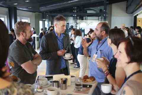 fellows and participants talking around a table at an event