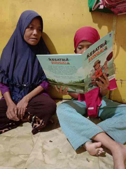 A little girl read changemaking book with her grandmother 