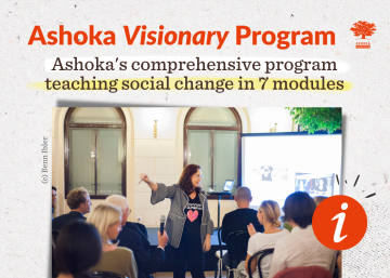 Photo of speakers looking towards the seated public in a hall in front of a screen, pointing to the right. Text reading "Ashoka's comprehensive program teaching social change in 7 modules".
