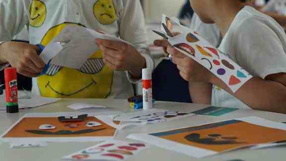 children cutting paper and making art