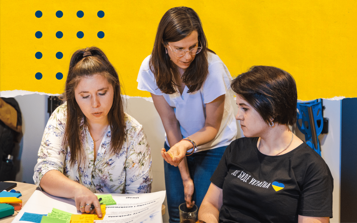 Three women working on buisness canva