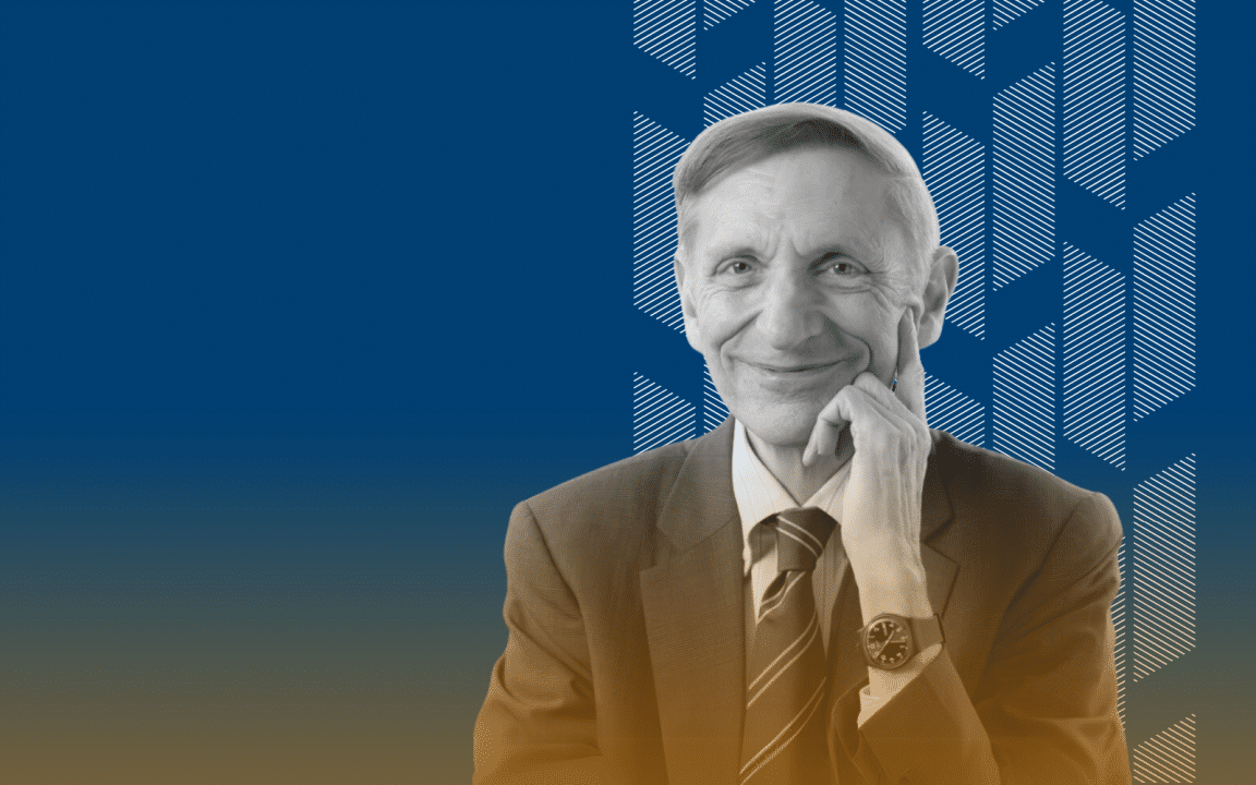 Fundo azul marinho com grafismos brancos à direita. Sobre o padrão de grafismos, há uma foto em preto e branco de Bill Drayton, homem branco de cabelos claros e curtos. Ele sorri levemente e veste um terno com gravata listrada e um relógio no pulso esquerdo. Na parte inferior, há um gradiente laranja