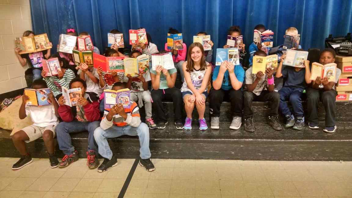 pic_with_students_holding_books_over_faces.jpg