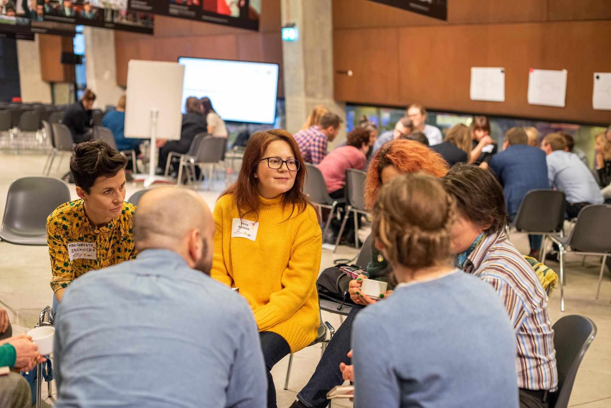 two group of people sitting in circles