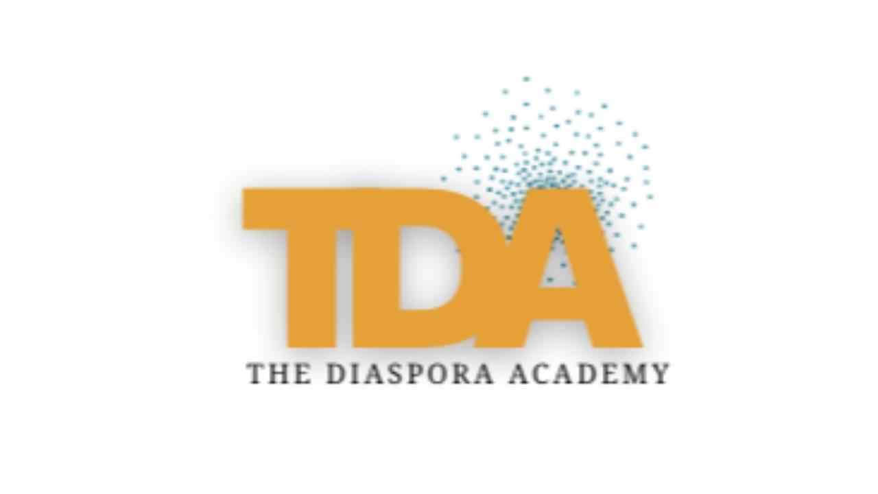 Logo with bold orange letters ‘TDA’ representing The Diaspora Academy. Behind the ‘A’ are scattered blue dots forming a cloud-like pattern. Below the main letters, the text reads ‘The Diaspora Academy’ in black capital letters.