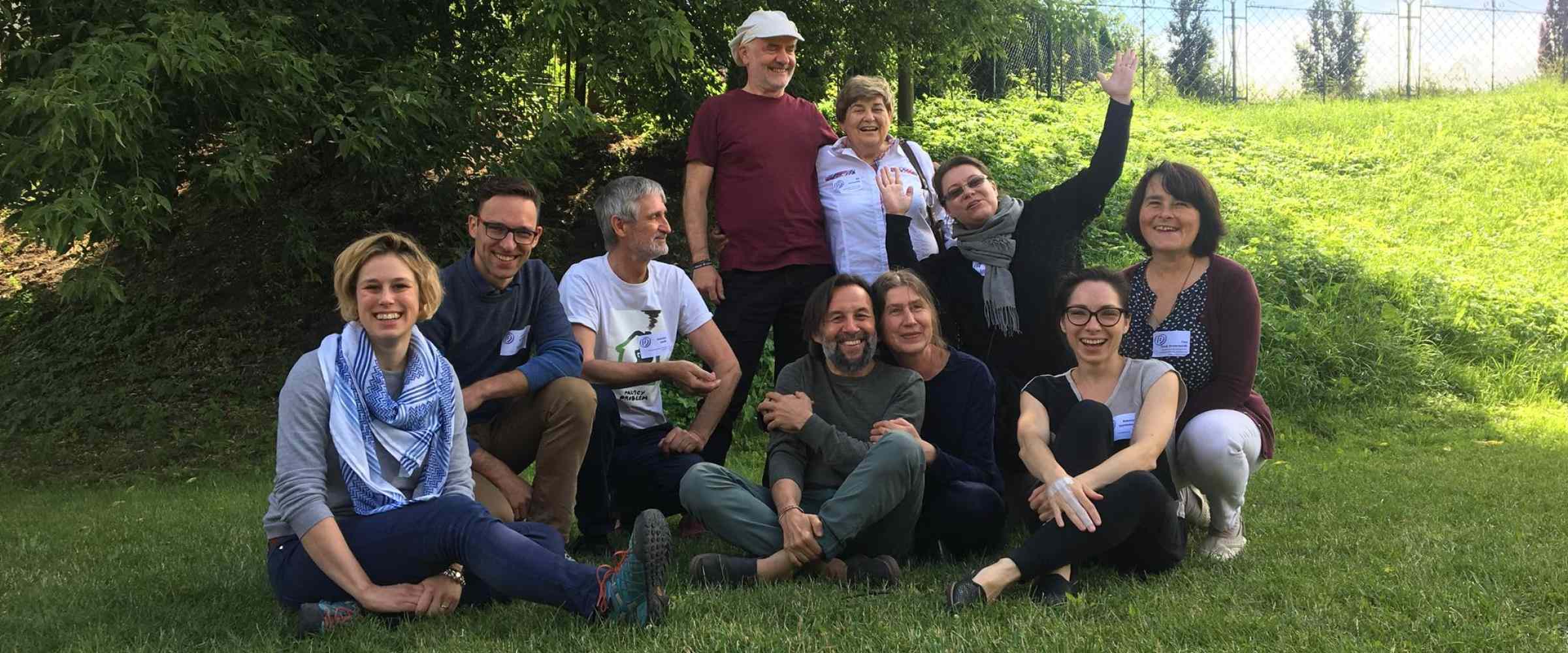 group of people sitting on the grass