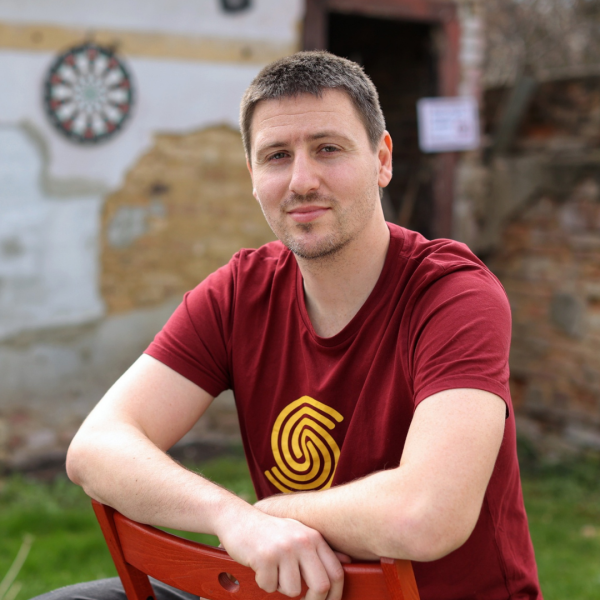 Young man sitting on a chair outside