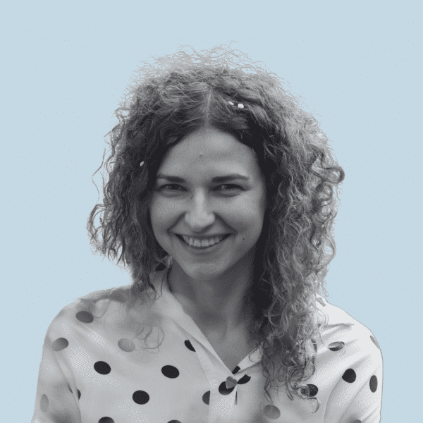 Young woman with curly hair, smiling