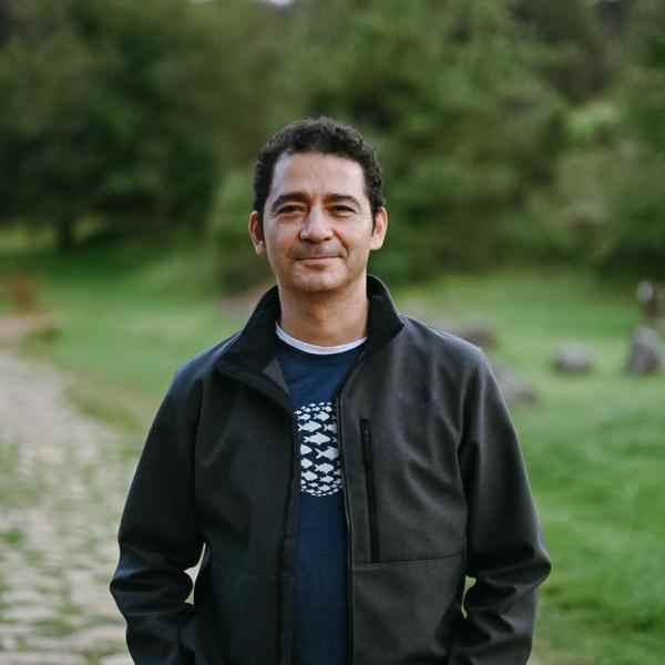 Picture of a man with dark hair wearing a black jacket