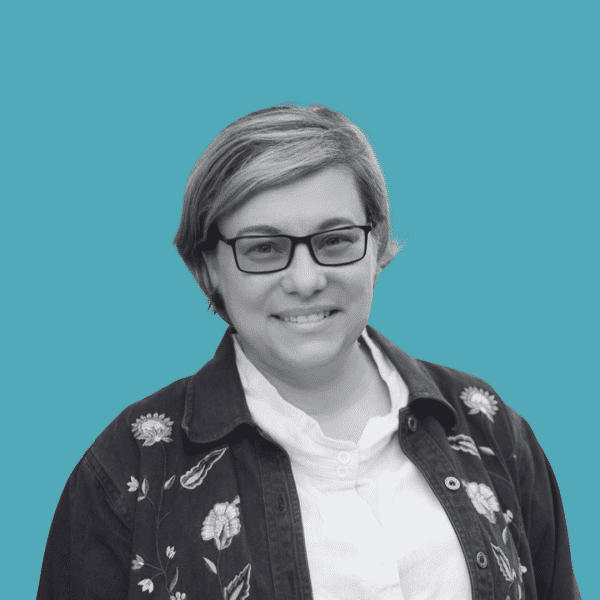 Woman in glasses smiling to the camera