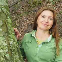 women in green shirt next to tree
