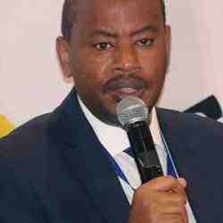 Mr Albert Nsengiyumva speaking into a mic