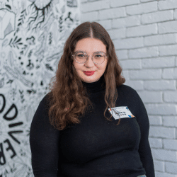 Young woman in a black jumper, waring glasses