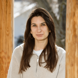 Young woman with long hair standing outside
