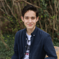 Youn man in a dark shirt sitting outside