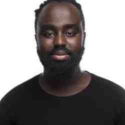Okong'o in a black shirt with a beard on a white background