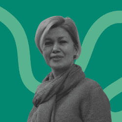 Grayscale portrait of a woman with light-colored hair, wearing a scarf and a jumper, facing the camera. The background is teal with abstract curved lines