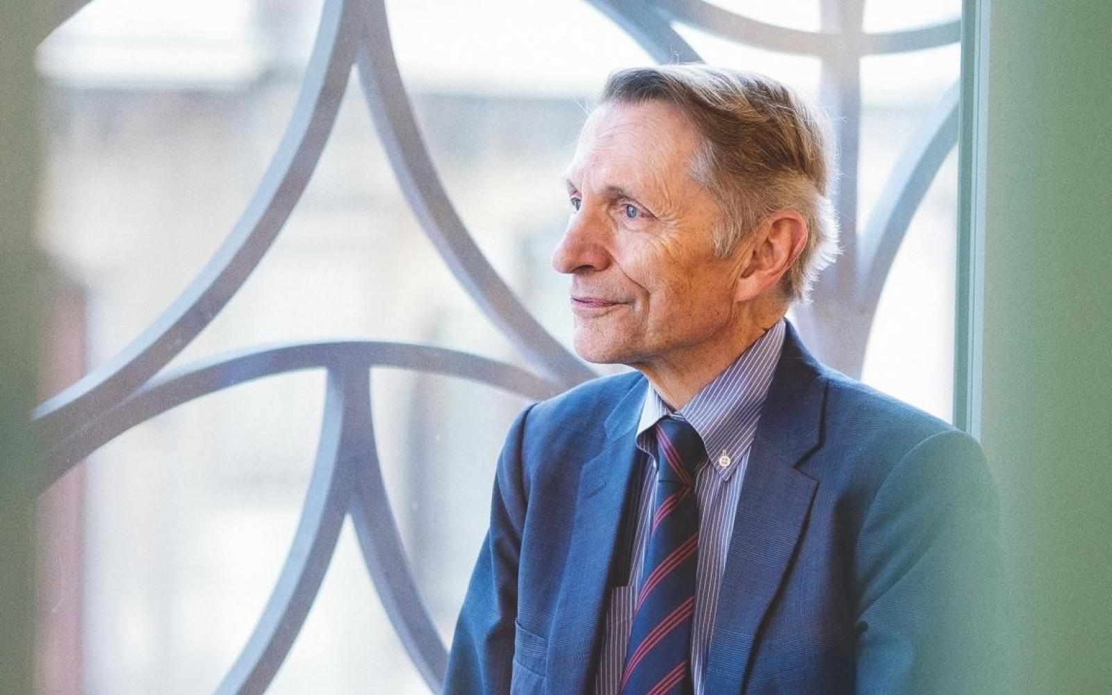 Bill Drayton by window facing left