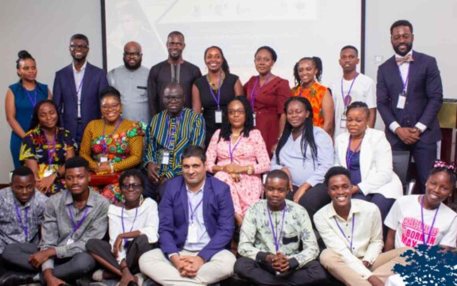 Photo of a group of people in three levels and three rows: sitting, kneeling and standing. Photo shows the Ashoka Nigeria team as well as 6 Young Changemakers at a launch event for the EACH movement in Nigeria