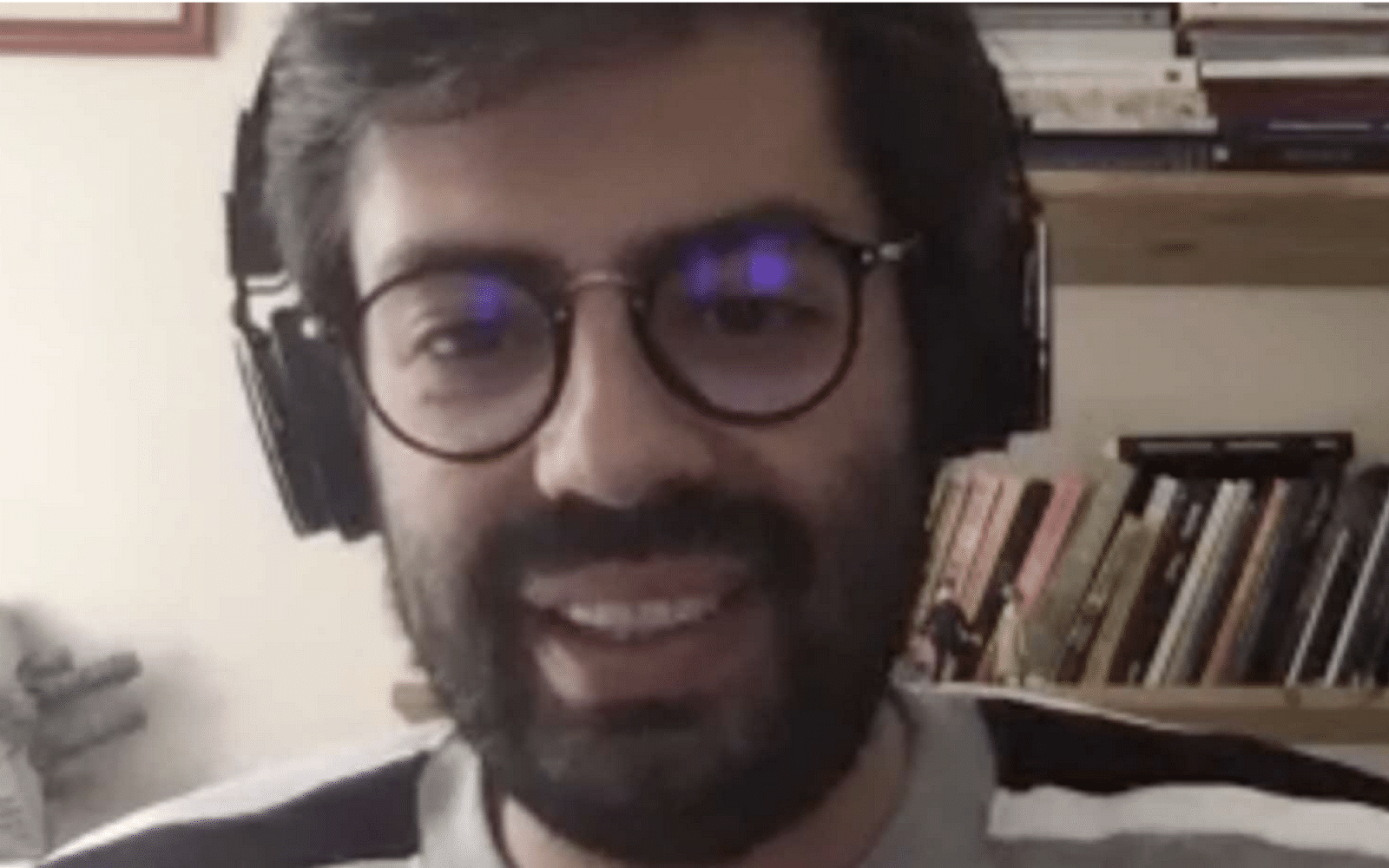 a man with glasses on webcam