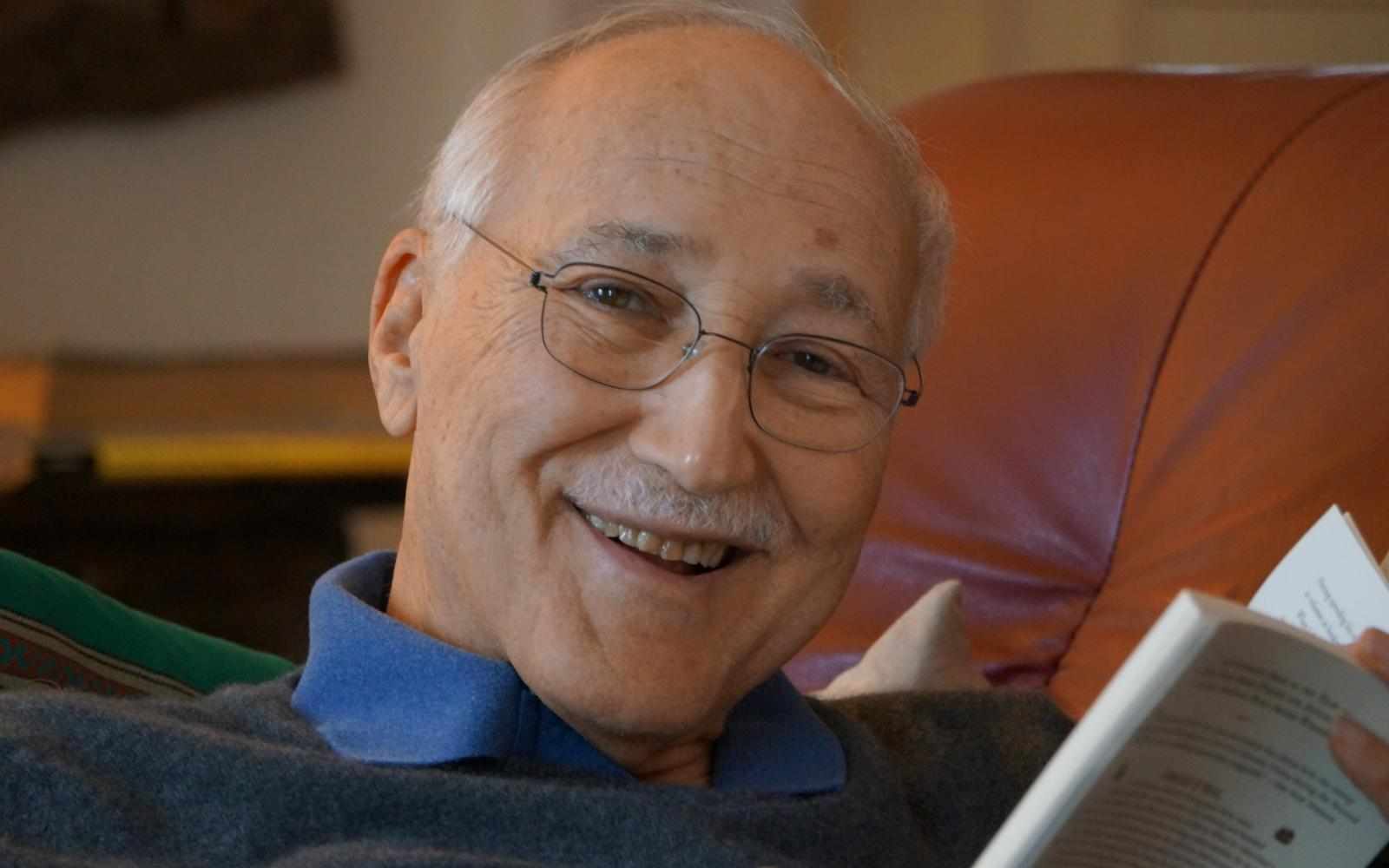 A photo of Philippe Villers holding a book