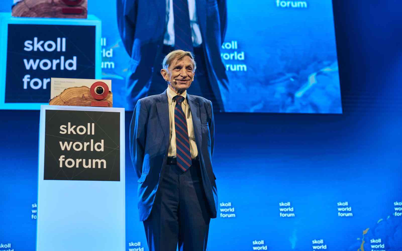 Bill Drayton facing audience front profile on stage at the Skoll Social Forum 2025