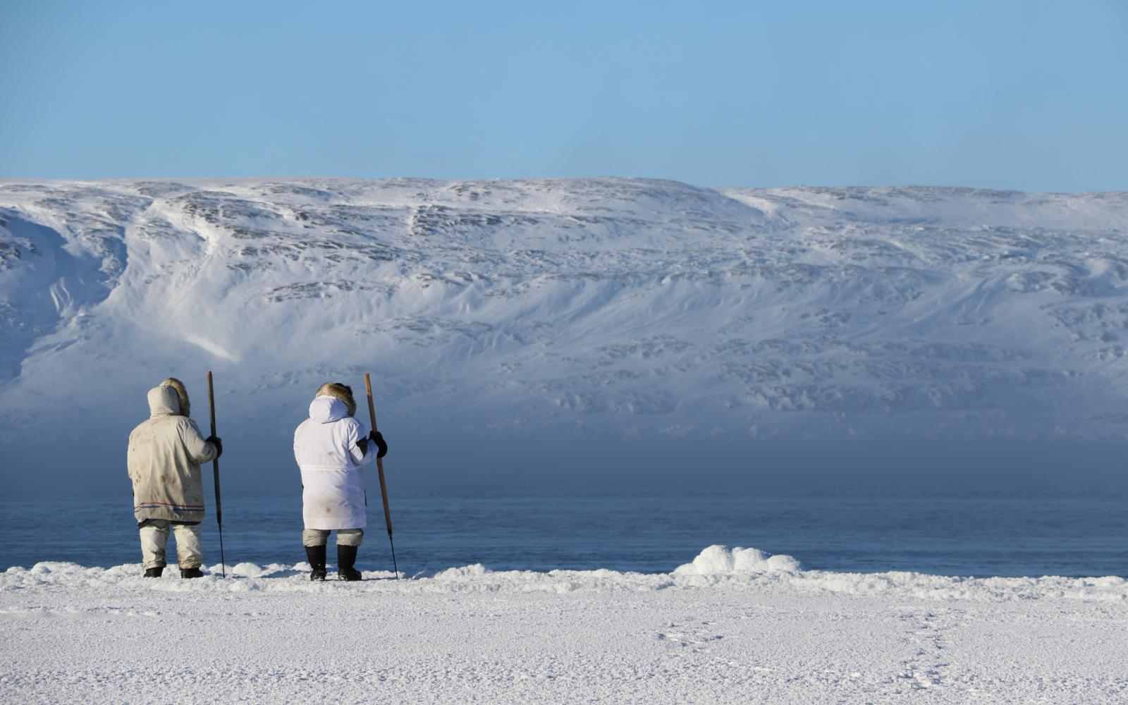 Hunters near Sanikiluaq involved in community-driven research programs; overlooking tundra and mountains