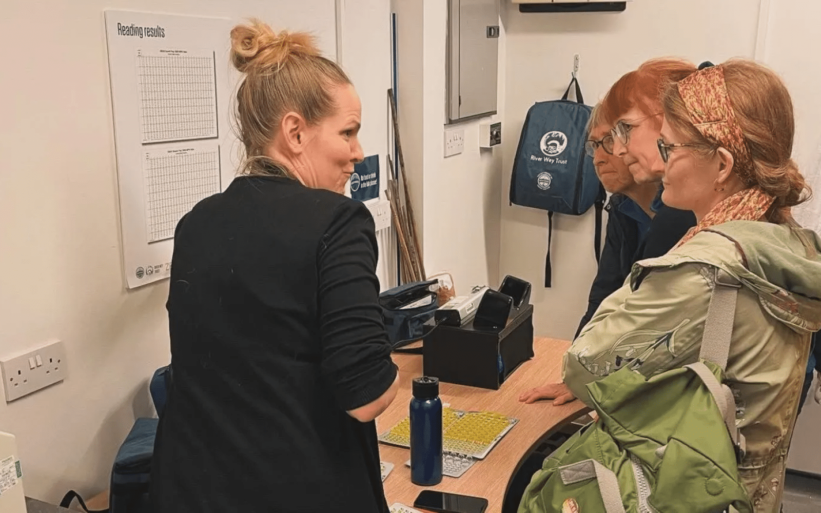 Ashoka Canada Fellow Kat Kavanagh discussing with three others in a lab