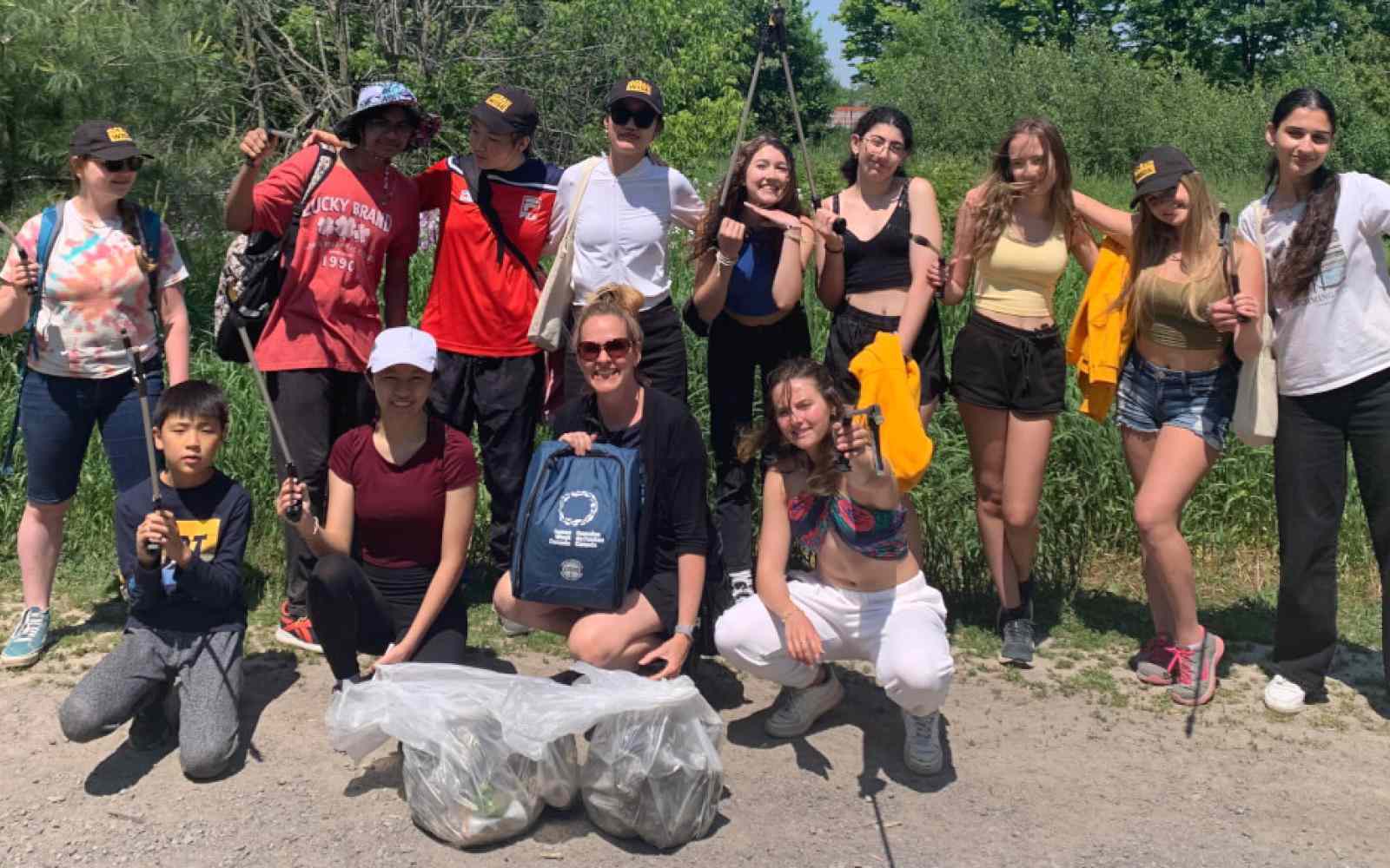 Group of youth smiling at the camera as part of Ashoka Canada Fellow Kat Kavanagh's project Water Rangers