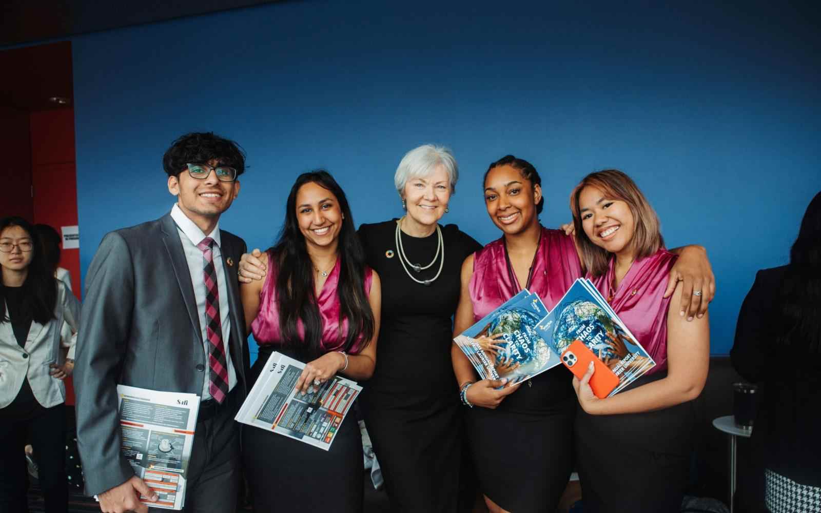 Group of students along with Laura Allan of Wilfrid Laurier University smiling at the camera