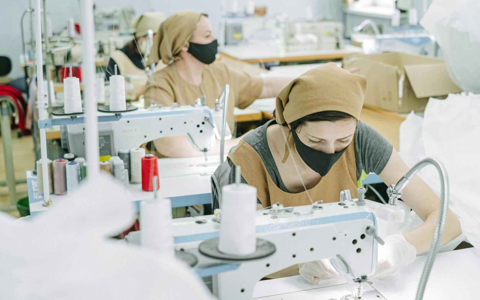 People working at sewing machines in a fashion studio
