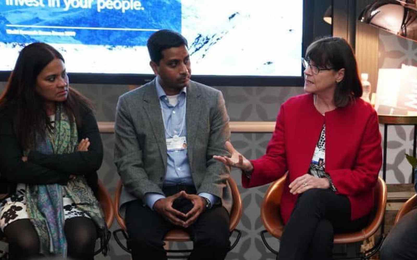 Group of people talking with each other; Janet Longmore at the right hand side