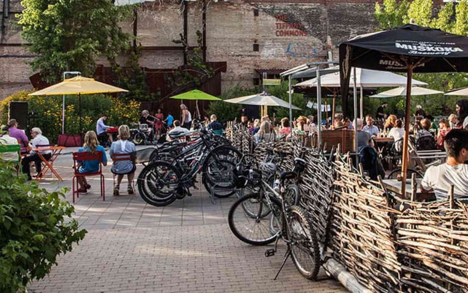 Photo of a square at Evergreen Brickworks where people are sitting. Bikes are all around