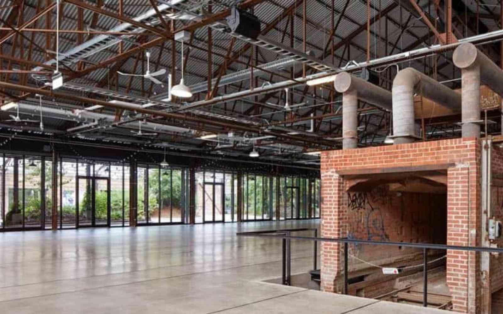 Photo of a brick kiln in an open glass building