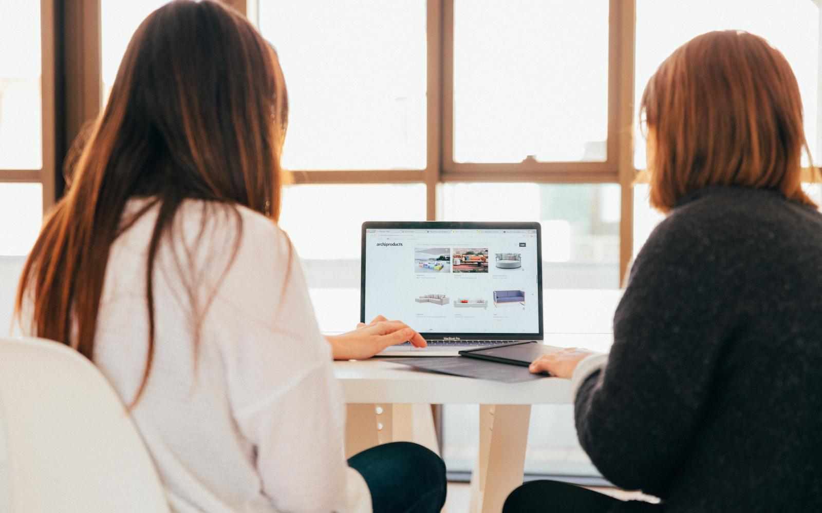 Two people looking at a computer in an office