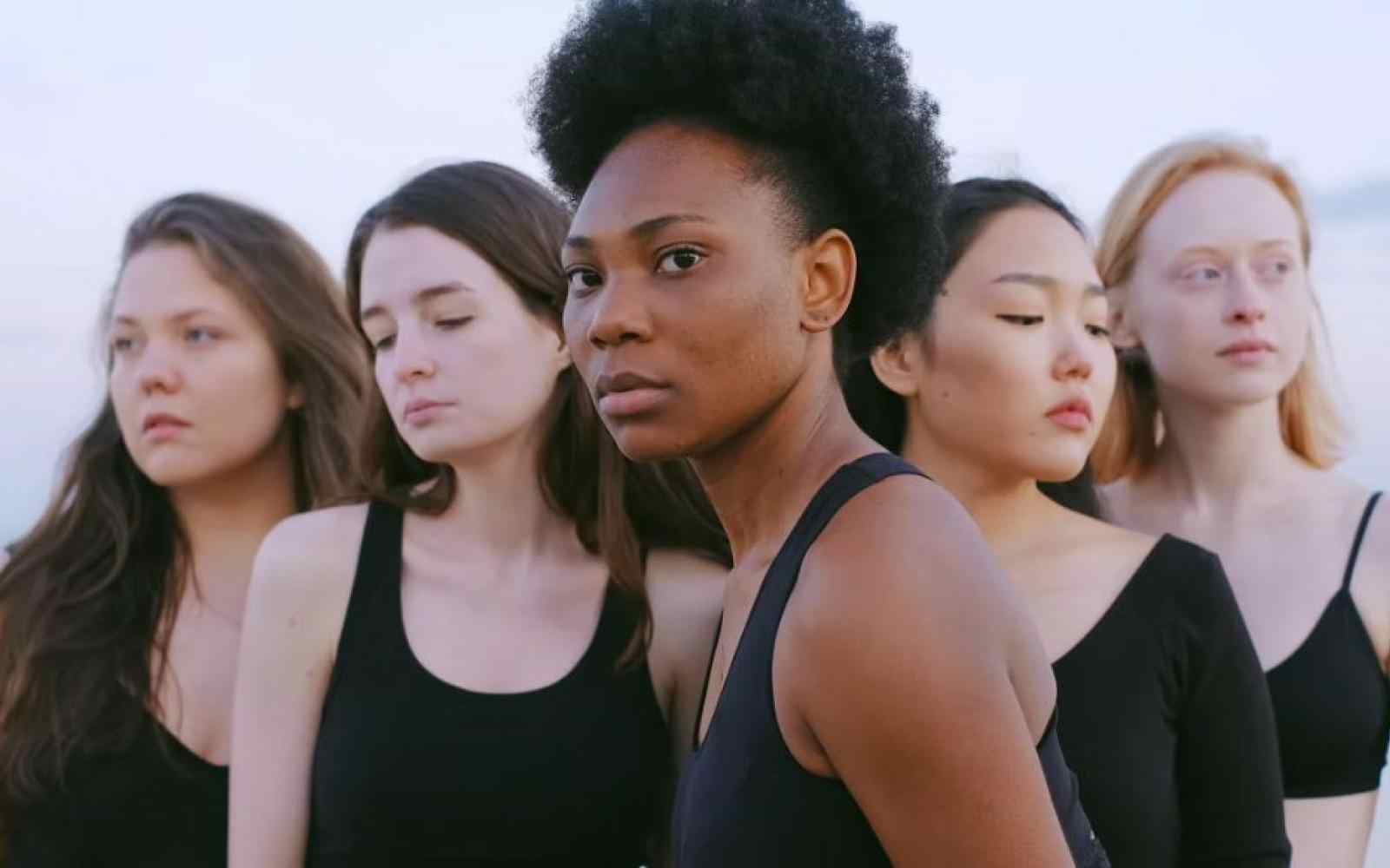 Five women in a line looking off camera