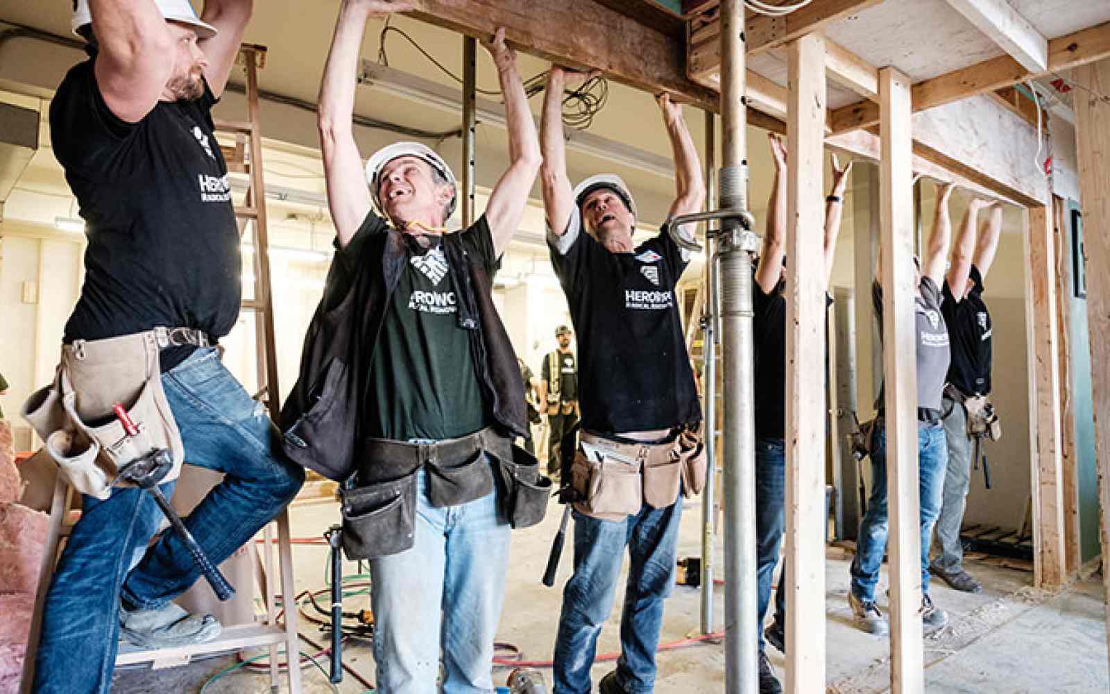 People working to build a building as part of HeroWork