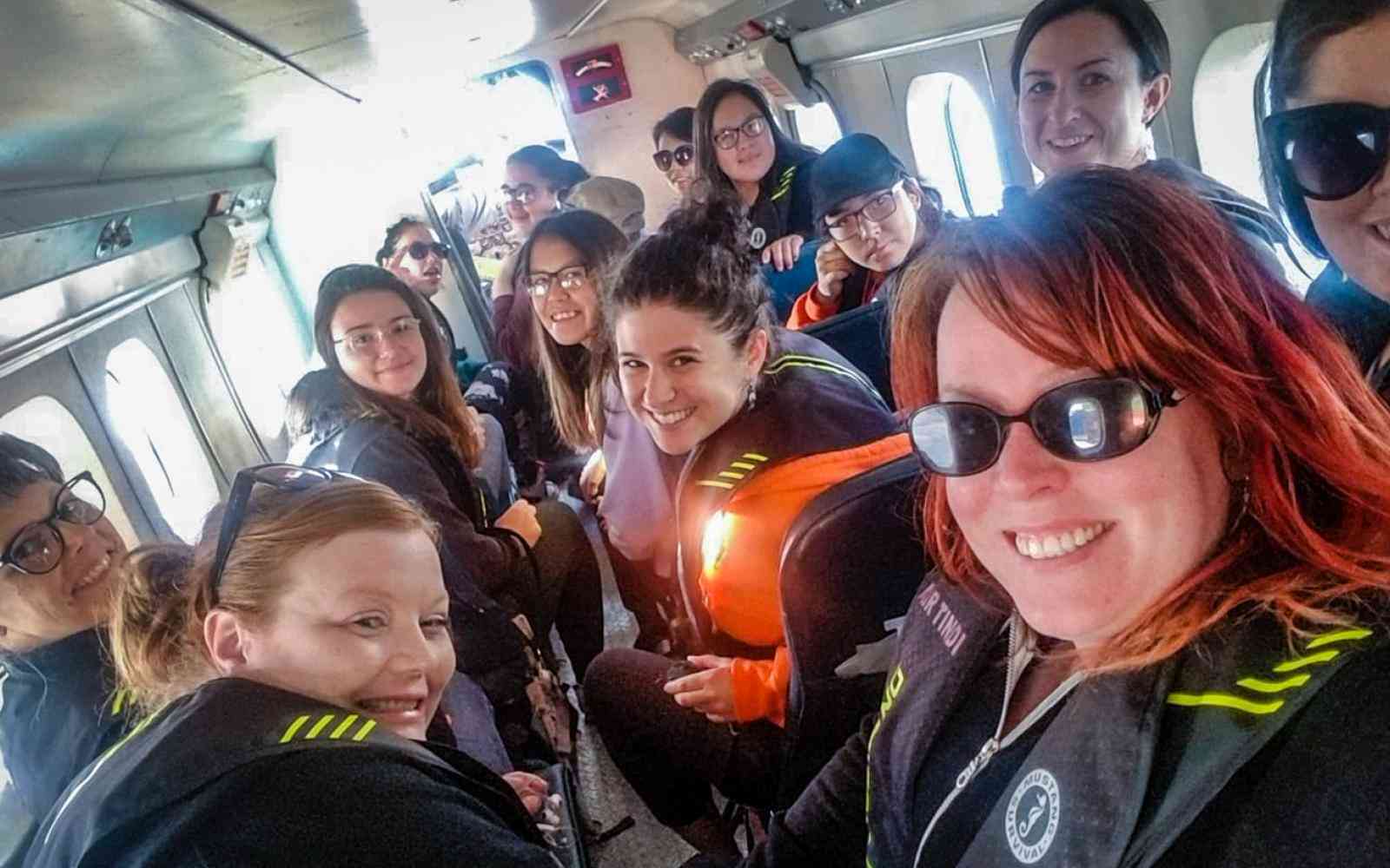 FOXY workshop participants and co-founder Nancy MacNeill board a plane to retreat 2018.jpg