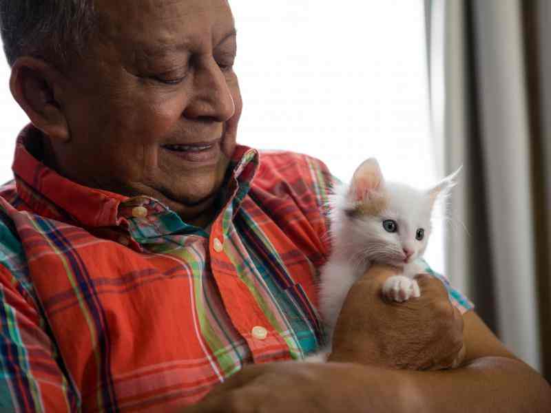 Older man holding a cat