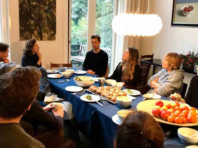 People sit around the table, talking