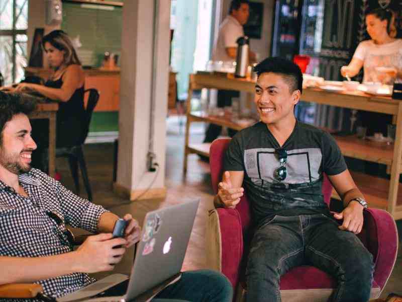 young people smiling at their computer