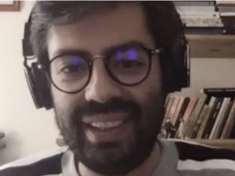 a man with glasses on webcam